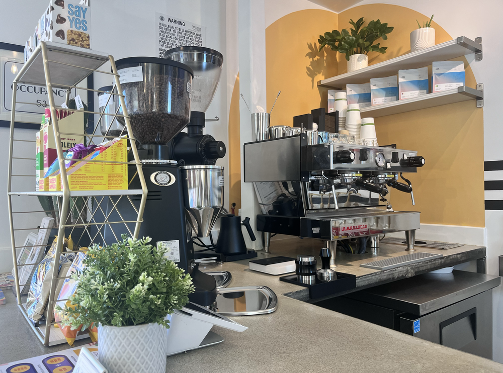 tumble Cafe espresso bar at tumble HAUS with a La Marzocco machine, coffee grinder and retail shelves